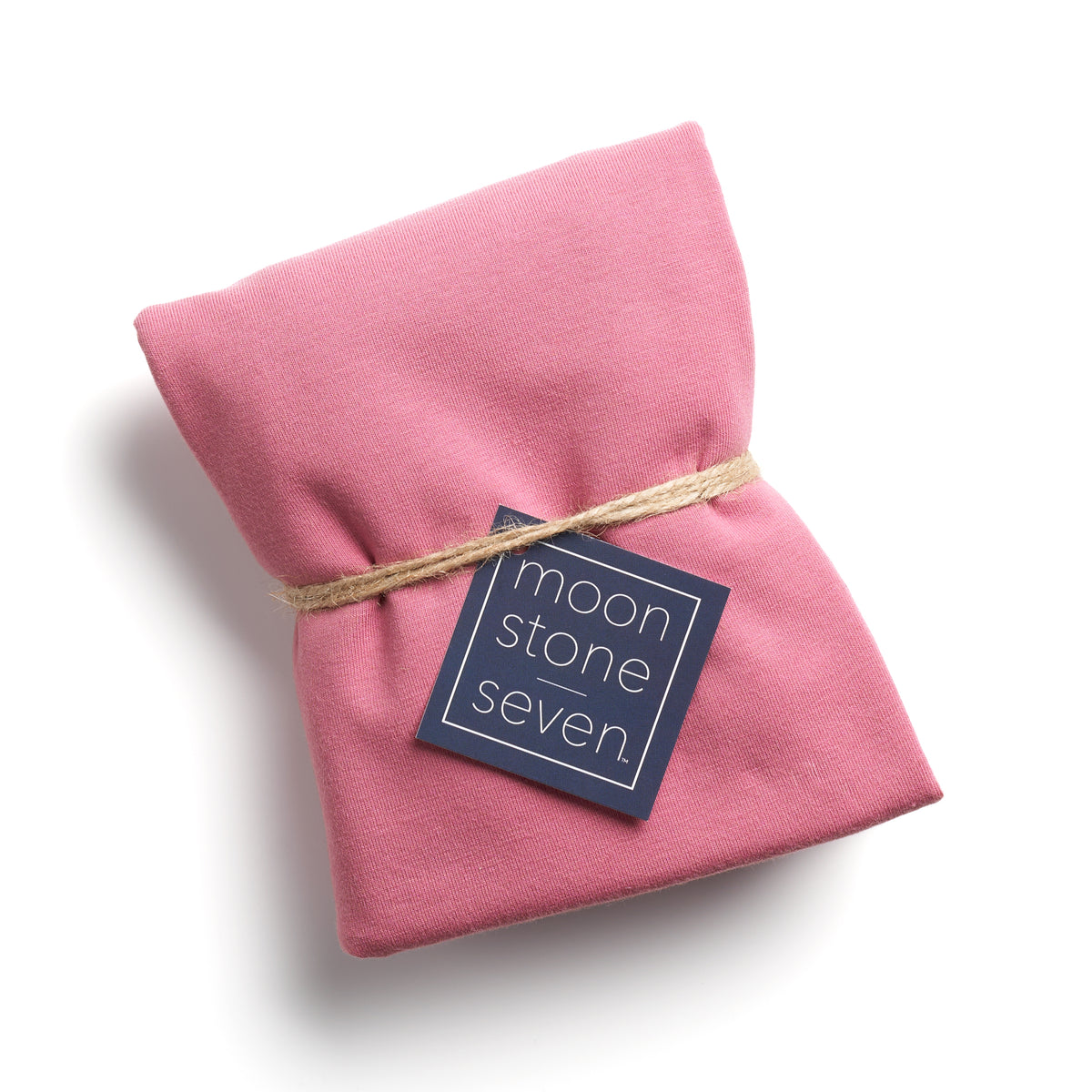 Mauve hair plop towel folded with MoonstoneSeven navy product tag and tied with twine