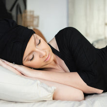 Load image into Gallery viewer, Model sleeping while wearing MoonstoneSeven Satin Sleeper to protect curls overnight