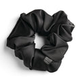 Black satin scrunchie for curly and wavy hair, gentle on strands and snag-free.