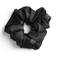 Black satin scrunchie for curly and wavy hair, gentle on strands and snag-free.