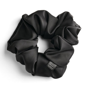 Black satin scrunchie for curly and wavy hair, gentle on strands and snag-free.