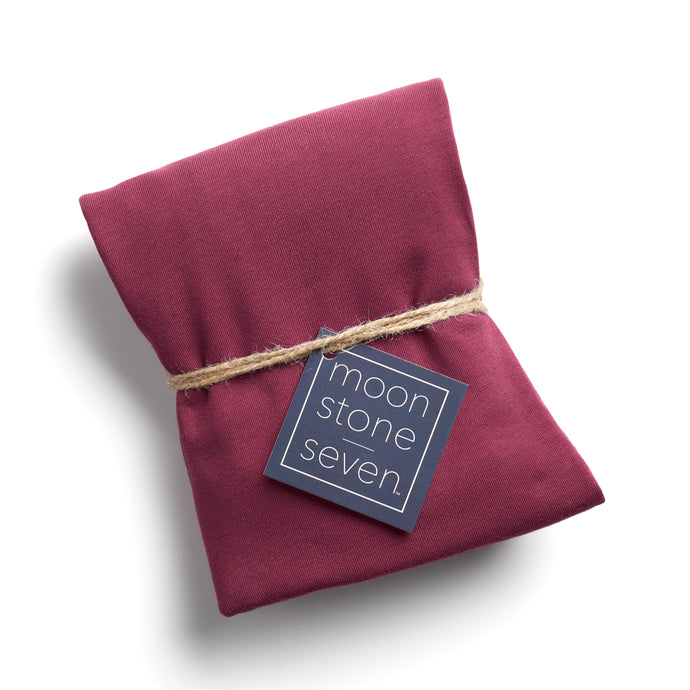 Berry Bliss hair plop towel folded with MoonstoneSeven navy product tag and tied with twine