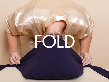 Step 2: Folding the hair plop over hair with a secure fit using the navy wrap