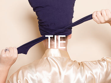 Step 4: Tying the ends of the Hair Plop to hold the wrap in place
