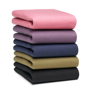 A stack of plops. Showing all 5 colors, starting with black on the bottom, then green, navy, plum and mauve