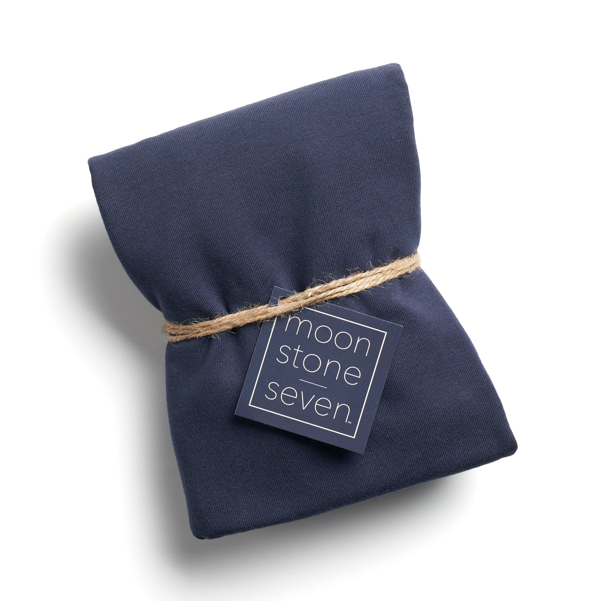 Navy hair plop towel folded with MoonstoneSeven navy product tag and tied with twine