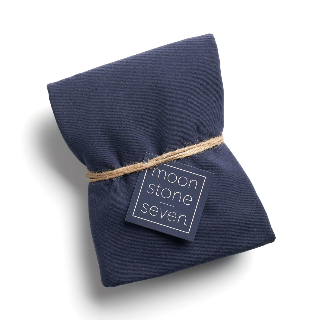 Navy hair plop towel folded with MoonstoneSeven navy product tag and tied with twine