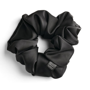Black satin scrunchie for curly and wavy hair, gentle on strands and snag-free.
